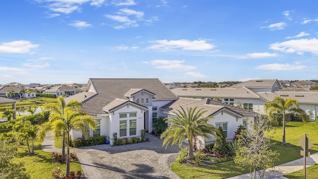 4673 Estates Cir, Westlake, FL 33470 - view of front of property with a residential view, stucco siding, a tiled roof, and a front yard