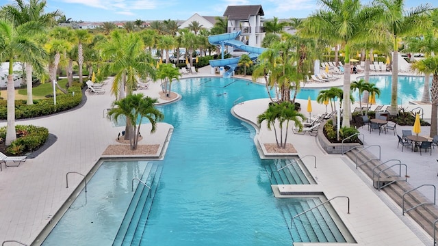 4673 Estates Cir, Westlake, FL 33470 - community pool featuring a water slide and a patio