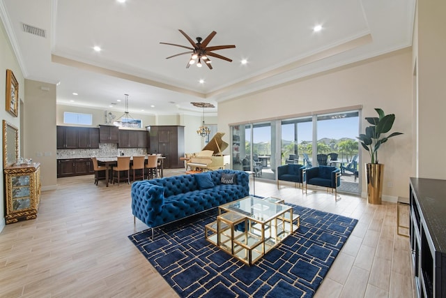 4673 Estates Cir, Westlake, FL 33470 - living area with a tray ceiling, ceiling fan, light wood-style flooring, recessed lighting, and a chandelier
