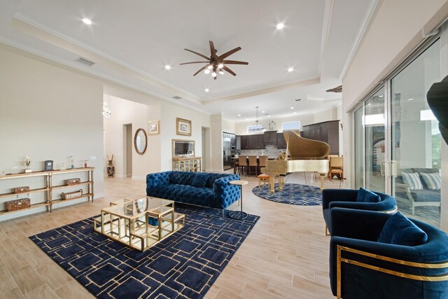 4673 Estates Cir, Westlake, FL 33470 - living area with a tray ceiling, a ceiling fan, ornamental molding, and recessed lighting