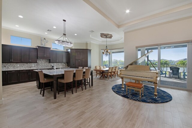 4673 Estates Cir, Westlake, FL 33470 - dining room with crown molding, plenty of natural light, a chandelier, light wood finished floors, and recessed lighting