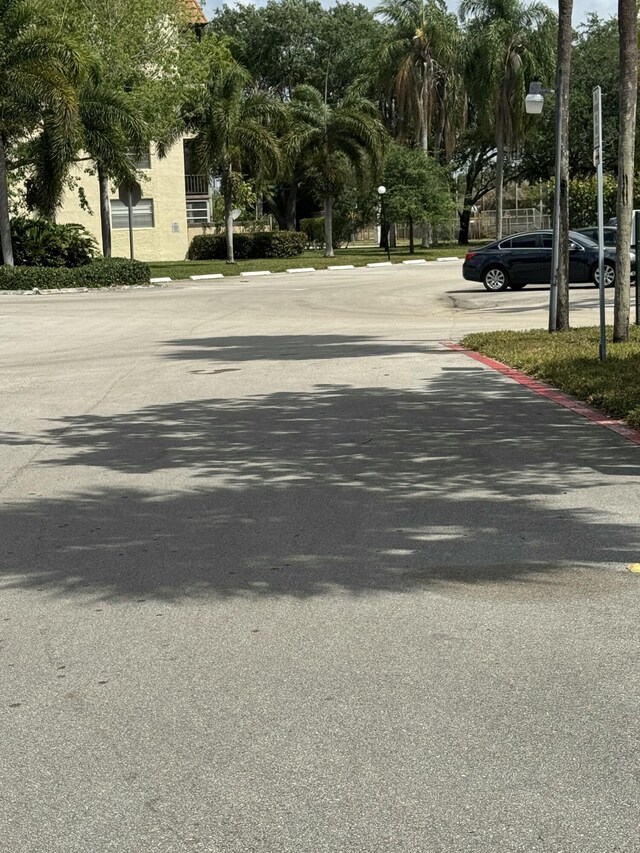 1681 NW 70th Ave Unit 102, Plantation, FL 33313 - view of asphalt road with street lights