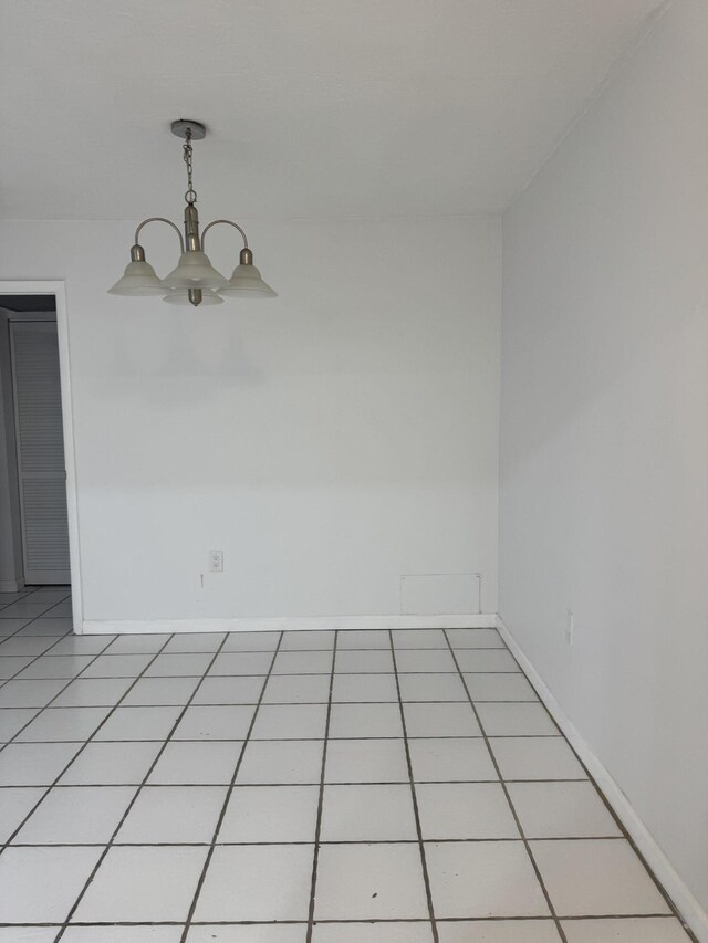 1681 NW 70th Ave Unit 102, Plantation, FL 33313 - spare room featuring baseboards and a chandelier