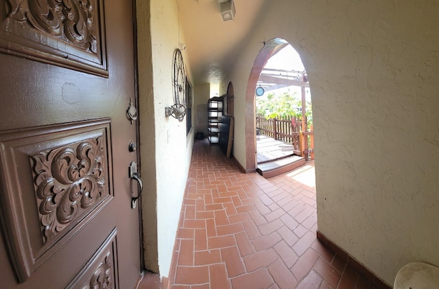 2379 Carambola Rd, West Palm Beach, FL 33406 - interior space with brick floors, a textured wall, and arched walkways