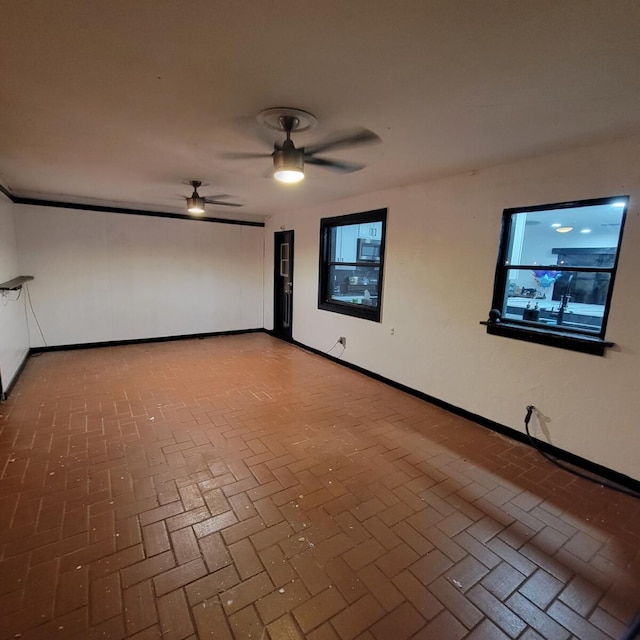 2379 Carambola Rd, West Palm Beach, FL 33406 - spare room featuring brick floors, ceiling fan, and baseboards