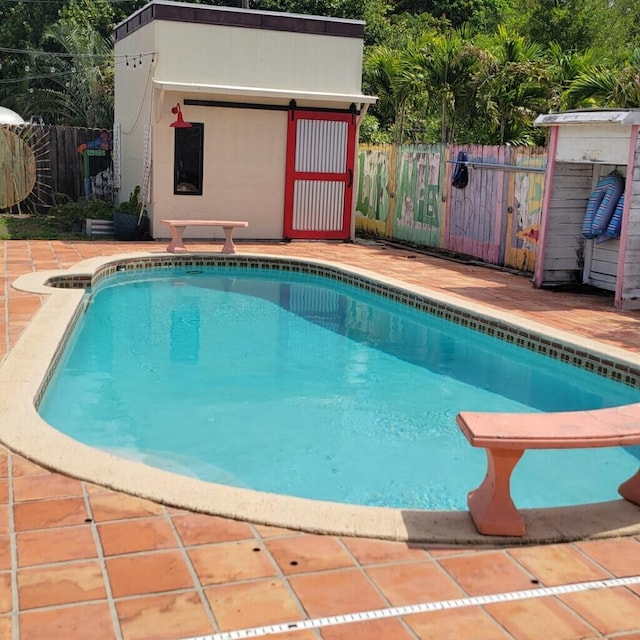 2379 Carambola Rd, West Palm Beach, FL 33406 - view of swimming pool featuring an outdoor structure and a patio