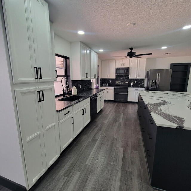 2379 Carambola Rd, West Palm Beach, FL 33406 - kitchen featuring black appliances, dark wood-style flooring, a sink, backsplash, and white cabinetry