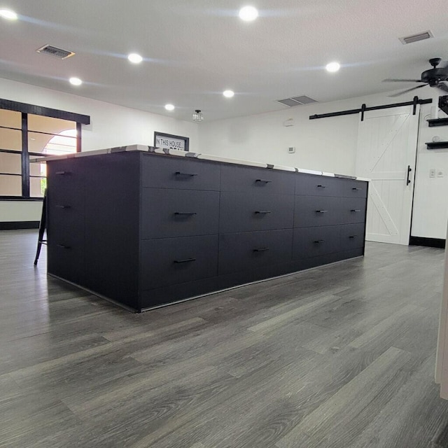 2379 Carambola Rd, West Palm Beach, FL 33406 - empty room featuring a barn door, dark wood-style floors, ceiling fan, recessed lighting, and baseboards