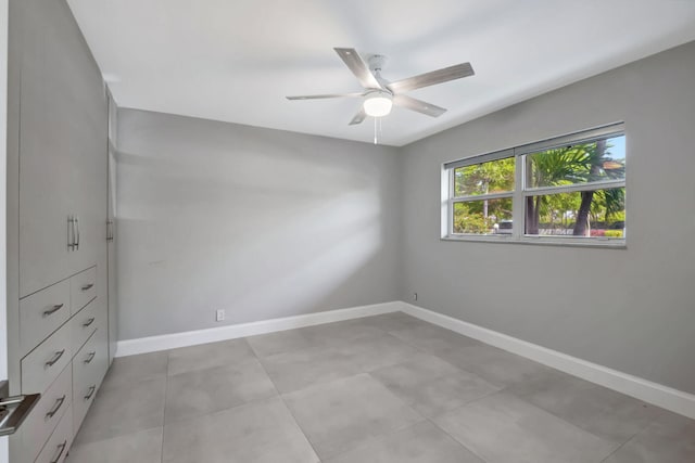 spare room featuring baseboards and ceiling fan