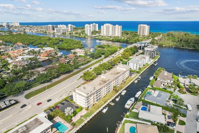 birds eye view of property featuring a water view and a city view