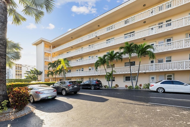 view of building exterior featuring uncovered parking