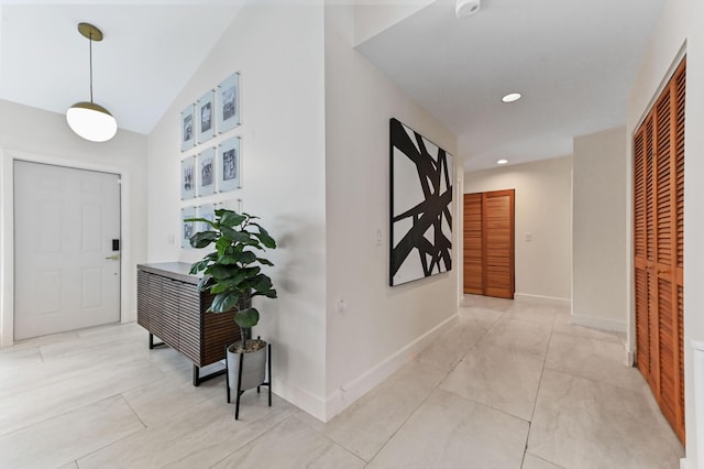 entrance foyer featuring lofted ceiling, baseboards, and recessed lighting
