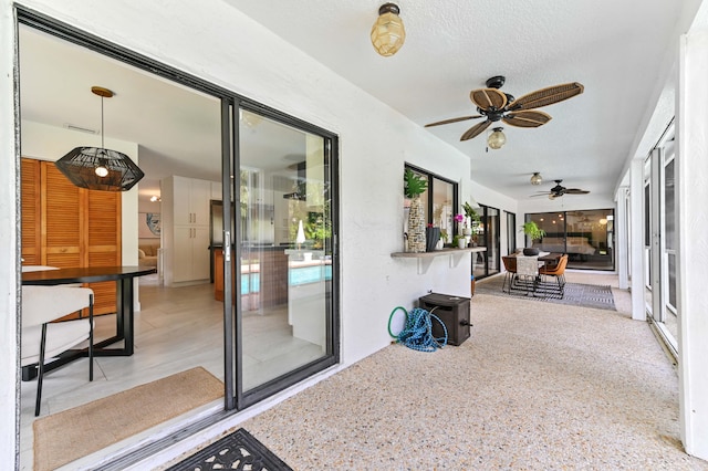 view of patio / terrace featuring ceiling fan and visible vents