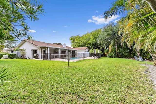 view of yard featuring a fenced backyard, a fenced in pool, and a sunroom