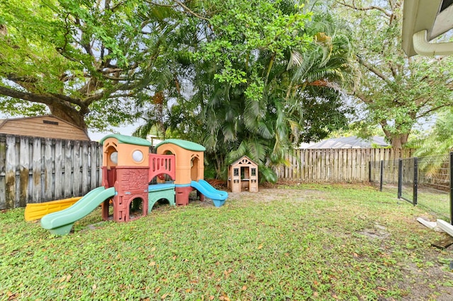 view of play area featuring a lawn and a fenced backyard