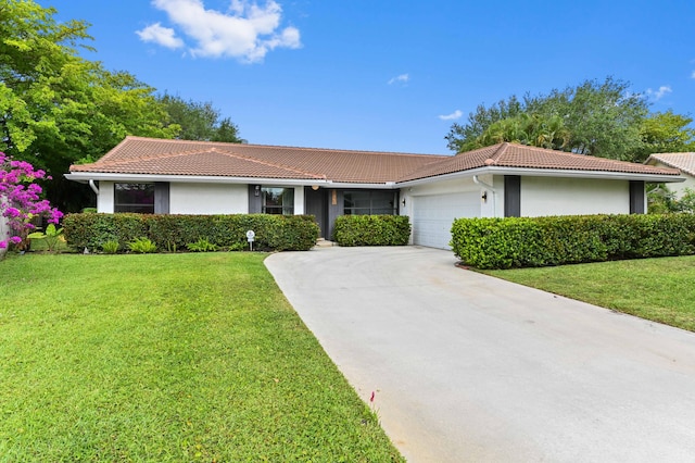 ranch-style house featuring stucco siding, an attached garage, a tiled roof, and a front yard