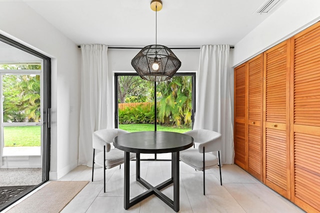 dining room with plenty of natural light, visible vents, and light tile patterned floors