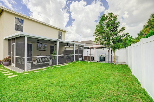 back of house with a fenced backyard, a sunroom, ceiling fan, and a gazebo