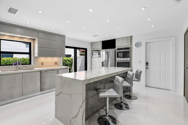 21481 Cypress Hammock Dr Unit 31B, Boca Raton, FL 33428 - kitchen with gray cabinets, visible vents, appliances with stainless steel finishes, modern cabinets, and a sink