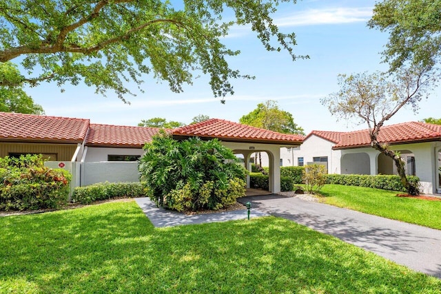 21481 Cypress Hammock Dr Unit 31B, Boca Raton, FL 33428 - mediterranean / spanish home featuring driveway, a tile roof, a front yard, fence, and stucco siding