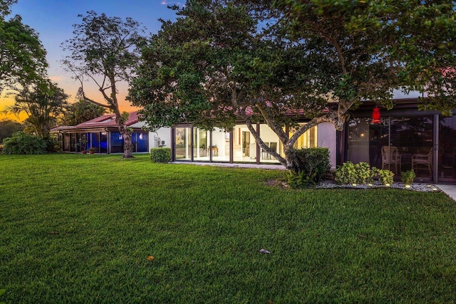21481 Cypress Hammock Dr Unit 31B, Boca Raton, FL 33428 - rear view of house with a yard, a sunroom, and stucco siding