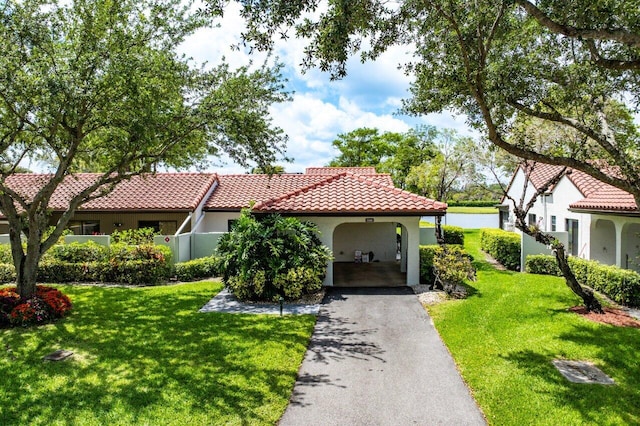 21481 Cypress Hammock Dr Unit 31B, Boca Raton, FL 33428 - mediterranean / spanish-style house with a tiled roof, driveway, a front lawn, and stucco siding