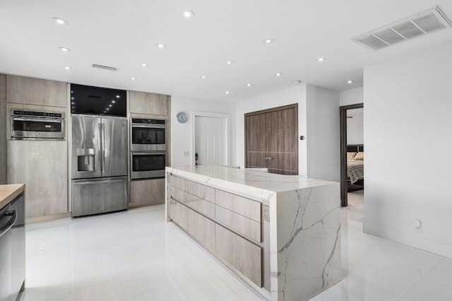21481 Cypress Hammock Dr Unit 31B, Boca Raton, FL 33428 - kitchen featuring appliances with stainless steel finishes, modern cabinets, and visible vents