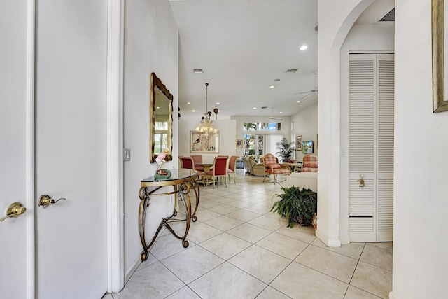 entryway with light tile patterned floors, recessed lighting, arched walkways, a ceiling fan, and baseboards