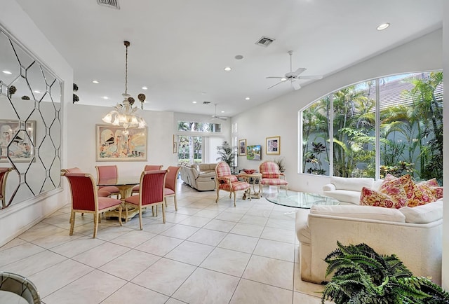 living area with recessed lighting, light tile patterned flooring, ceiling fan, and a chandelier