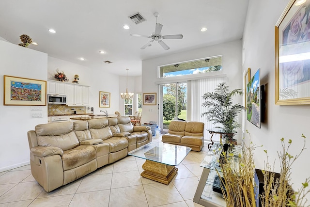 living room with a chandelier, ceiling fan, recessed lighting, and light tile patterned floors