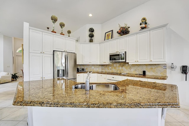kitchen featuring stainless steel appliances, a sink, decorative backsplash, light tile patterned flooring, and recessed lighting