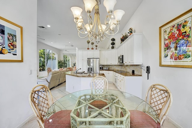 dining space with light tile patterned floors, a chandelier, baseboards, and recessed lighting