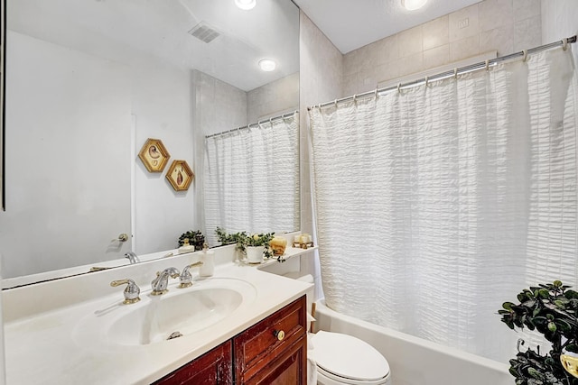 bathroom featuring shower / bathtub combination with curtain, toilet, and vanity