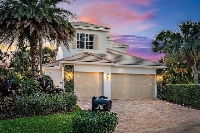 17065 Bay St, Jupiter, FL 33477 - back of property featuring stucco siding, a tile roof, and a balcony