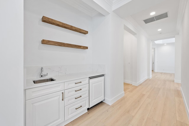 17065 Bay St, Jupiter, FL 33477 - bar with ornamental molding, wet bar, visible vents, light wood finished floors, and a sink