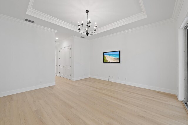 17065 Bay St, Jupiter, FL 33477 - empty room featuring a tray ceiling, visible vents, a chandelier, light wood finished floors, and baseboards