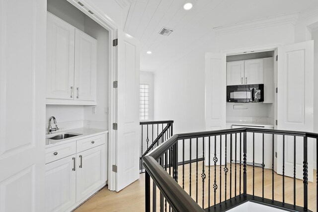 17065 Bay St, Jupiter, FL 33477 - corridor featuring recessed lighting, an upstairs landing, light wood-style floors, visible vents, and a sink
