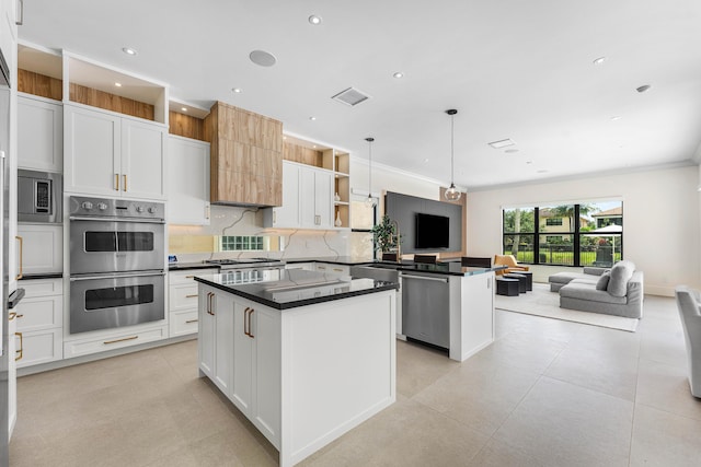 16491 Gateway Bridge Dr, Delray Beach, FL 33446 - kitchen with stainless steel appliances, open floor plan, dark countertops, a peninsula, and a kitchen island