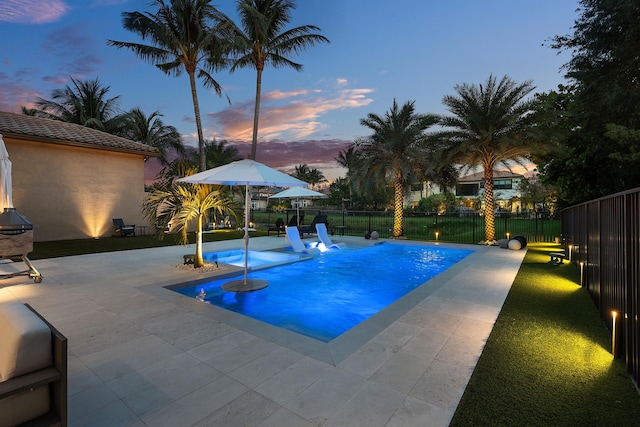 16491 Gateway Bridge Dr, Delray Beach, FL 33446 - pool at dusk with a patio area and a fenced backyard