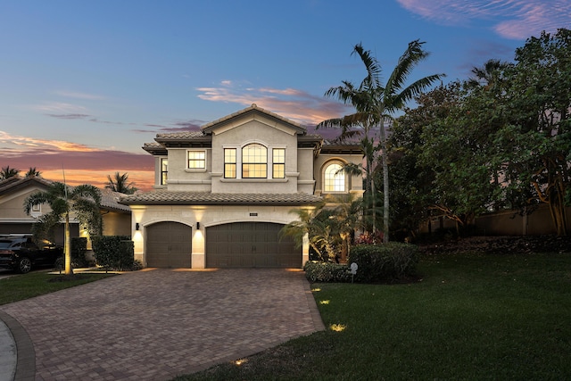 16491 Gateway Bridge Dr, Delray Beach, FL 33446 - mediterranean / spanish-style home with decorative driveway, a garage, a tile roof, a yard, and stucco siding