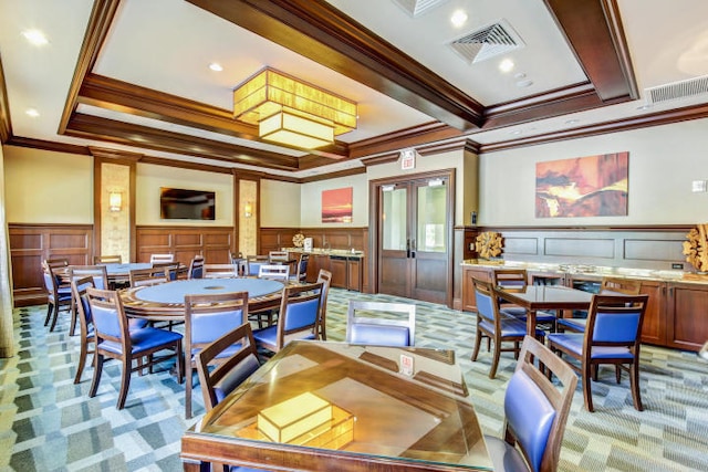 16491 Gateway Bridge Dr, Delray Beach, FL 33446 - dining room with a decorative wall, ornamental molding, light carpet, wainscoting, and coffered ceiling