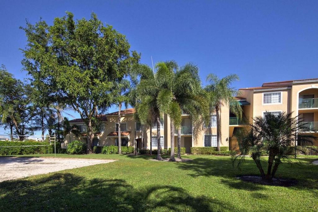 view of home's community featuring a yard and volleyball court