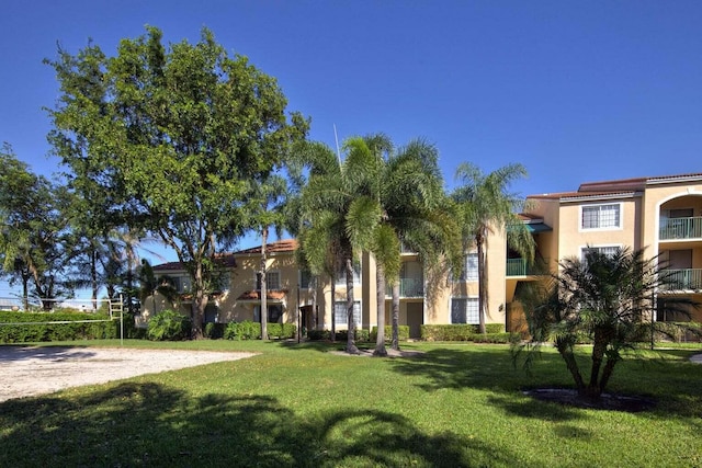 view of home's community featuring a yard and volleyball court