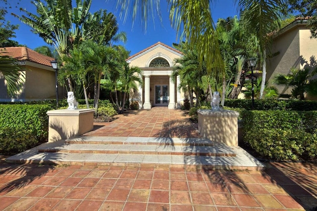 view of front of property with stucco siding and french doors