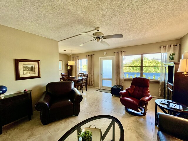 4015 Islewood D, Deerfield Beach, FL 33442 - living room featuring a textured ceiling, ceiling fan, and light tile patterned flooring