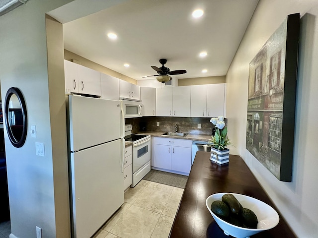 4015 Islewood D, Deerfield Beach, FL 33442 - kitchen with decorative backsplash, white cabinetry, a sink, and white appliances