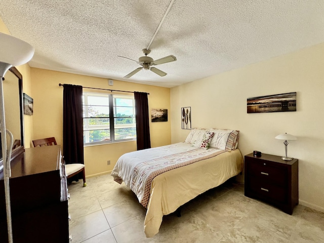4015 Islewood D, Deerfield Beach, FL 33442 - bedroom with light tile patterned floors, a textured ceiling, baseboards, and a ceiling fan