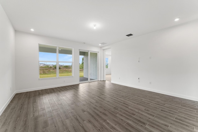 spare room featuring visible vents, dark wood-style floors, baseboards, and recessed lighting