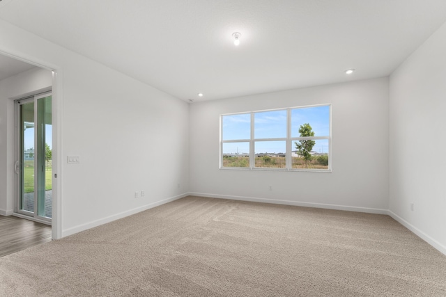 unfurnished room featuring baseboards, carpet floors, and recessed lighting