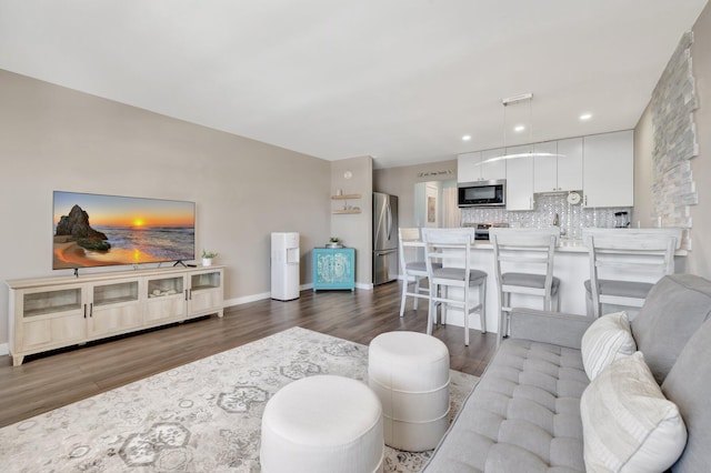2081 NE 56th St Unit 207, Fort Lauderdale, FL 33308 - living area featuring dark wood-style flooring, baseboards, and recessed lighting